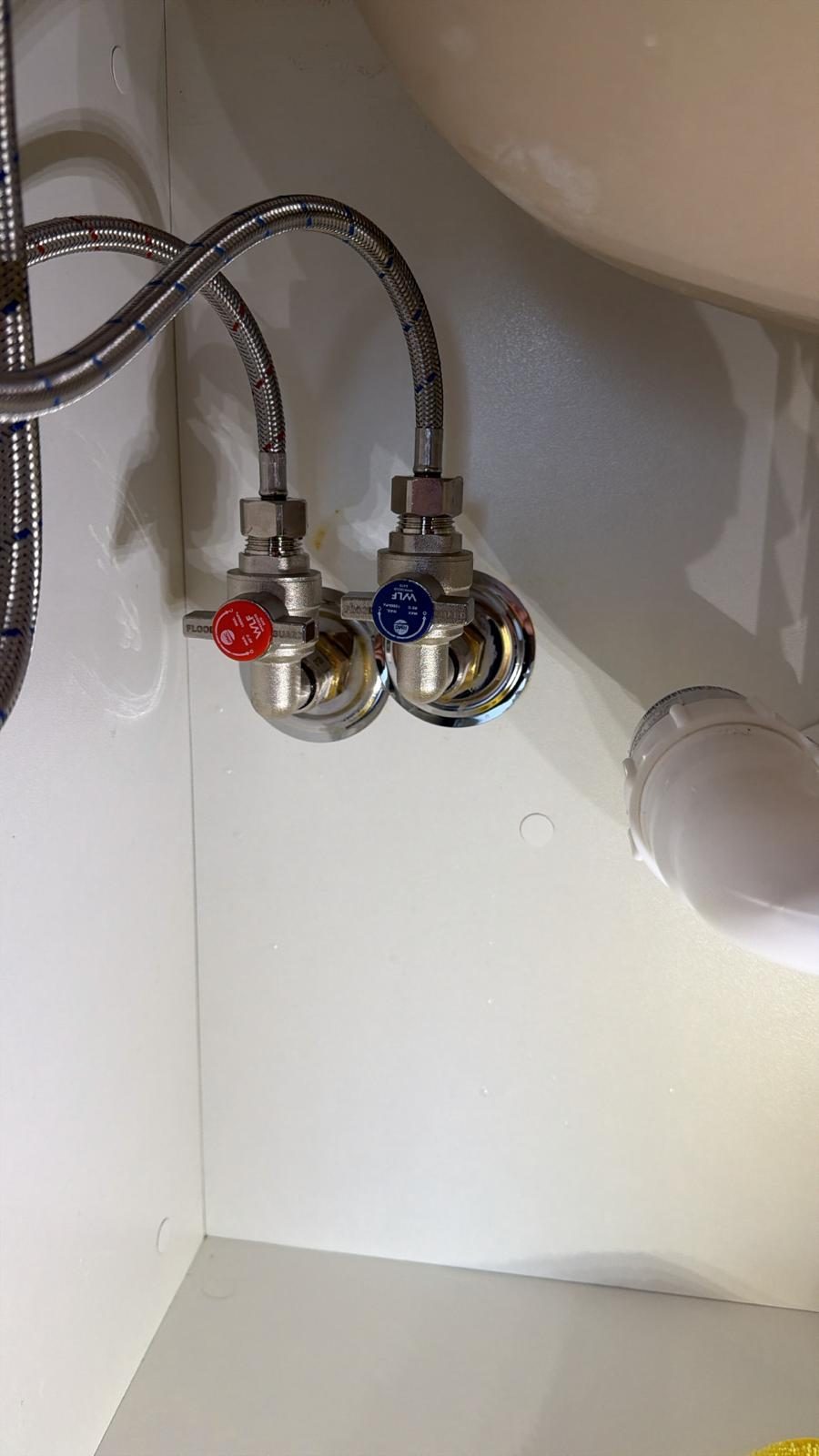 RMC FloodGuard valves installed under bathroom vanity basin with new flexi hoses by Scarborough Plumbing